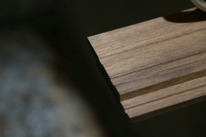 a close up of a watch on a wooden surface